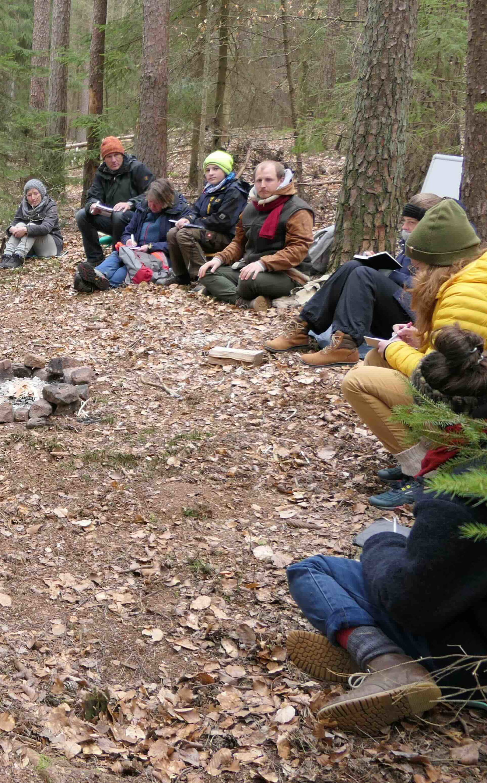 A group sitting in a circle in the forest